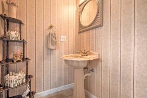 a bathroom with a sink and a mirror at Charming Burnsville Apartment with Stunning Views! in Burnsville