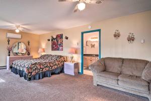 a bedroom with a bed and a couch and a mirror at Burnsville Hideaway with Deck and Panoramic Mtn Views in Burnsville