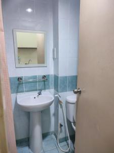 a bathroom with a sink and a toilet and a mirror at Sofea Inn Bukit Merah - Laketown D6529 in Kampong Selemat