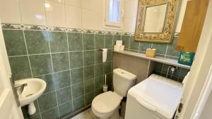 a bathroom with a toilet and a sink and a mirror at Les Volets Bleus in Saint-Valery-sur-Somme +17 photos