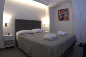 Ένα ή περισσότερα κρεβάτια σε δωμάτιο στο Synathens II - Apartments & Studios