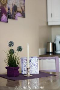 a candle sitting on top of a table at Friendly Home - Doppelappartement "Purple" Köln Bonn Phantasialand in Brenig