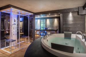 a bathroom with a large tub and a shower at Chalet Cashmere Spirit - OVO Network in Manigod