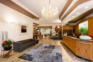 a living room with a chandelier and a lobby at Hotel Italy in Bibione