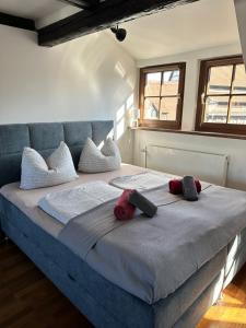 a large bed with two pillows on top of it at Gästehaus Glücksmoment in Erfurt
