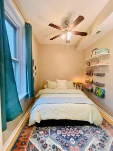 a bedroom with a bed and a ceiling fan at Sunny, Spacious, 3BR 1BA Davlin INN Chicago in Chicago