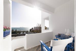 a dining room with a view of the ocean at Nataly's Apartments in Gavrio