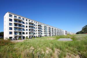 a large white apartment building on the beach at App Prora Solitaire FeWo 8 Balkon, Strand, Wellness in Binz