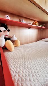two stuffed animals sitting on top of a bed at Casa Vacanze "LA TERRAZZA" in Leporano