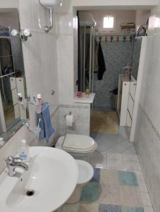 La salle de bains est pourvue d'un lavabo blanc et de toilettes. dans l'établissement B&B Angolo Verde, à Terni