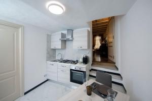 a kitchen with white cabinets and a wooden table at Villa Albaluce in Caluso