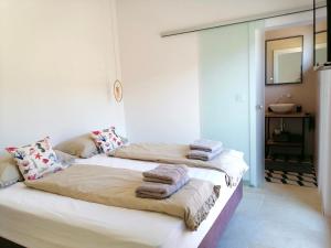 two beds in a room with towels on them at Villa Bora - Blue Flat Green Flat in Slatine +44 photos
