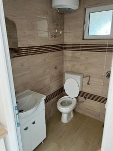 a small bathroom with a toilet and a sink at Apartments Betti in Ulcinj