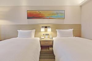 Voodi või voodid majutusasutuse Santos Hotel toas