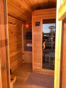 a wooden cabin with a door and a window at Sable Point Cottage (Lakeside 7-Person Hot Tub & Outdoor Shower) in Grand River