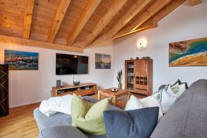 ein Wohnzimmer mit einem Sofa und einem TV in der Unterkunft Bergtraum in Garmisch-Partenkirchen