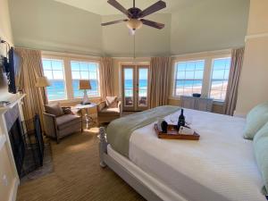 a bedroom with a bed with a ceiling fan at Henderson Park Inn in Destin