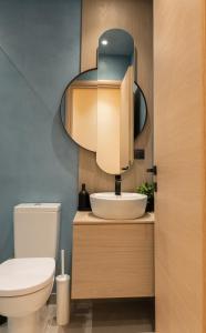 a bathroom with a sink and a mirror at MadaM Apartments - elegant, cozy, comfortable, central in Ioannina