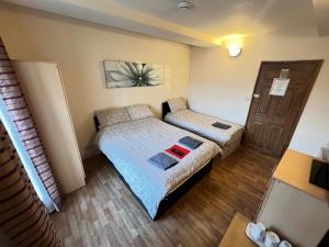 a small bedroom with a bed and a couch at The Old Post Office Public House & Hotel in Halifax