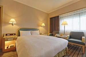 Voodi või voodid majutusasutuse Santos Hotel toas