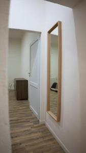 a white room with a mirror and a door at Casa Emilia [centro storico] in Imola