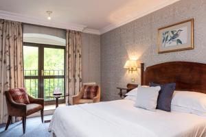 a hotel room with a bed and a window at The Petersham in Richmond upon Thames
