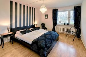 a bedroom with a large bed and a window at Villa Schönau in Bad Münstereifel