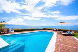 a swimming pool with a view of the ocean at Casa Lido in Puerto Vallarta