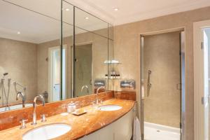 a bathroom with two sinks and a shower at The Petersham in Richmond upon Thames