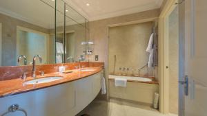 a bathroom with two sinks and a shower at The Petersham in Richmond upon Thames