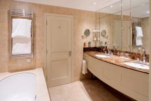 a bathroom with two sinks and a tub and a mirror at The Petersham in Richmond upon Thames +37 photos