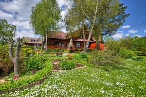 a garden in front of a house with flowers at Widok in Cisna