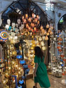 a woman walking in front of a display of lights at Key Of Life House in Luxor