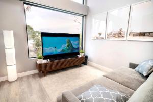 een woonkamer met een grote flatscreen-tv bij Bright European Loft In Venice Beach in Los Angeles