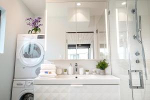 a bathroom with a sink and a washing machine at Bright European Loft In Venice Beach in Los Angeles