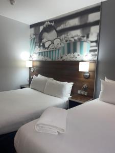 two beds in a hotel room with white sheets at Heeton Concept Hotel - City Centre Liverpool in Liverpool