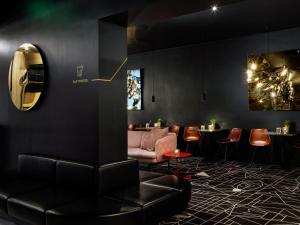 a black room with a couch and a table at Mabi City Centre Hotel in Maastricht