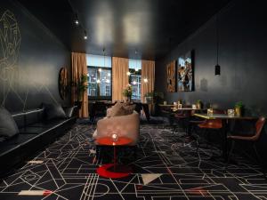 a living room with a couch and a table at Mabi City Centre Hotel in Maastricht