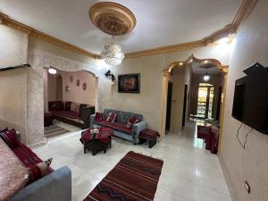a large living room with couches and a tv at Petra View Flat in Wadi Musa
