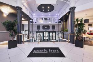 a lobby with a park inn palestine sign on a rug at Park Inn by Radisson Cardiff City Centre in Cardiff