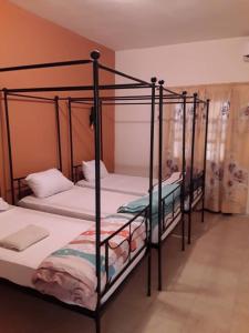 two black bunk beds in a room at HÔTEL ETOILE DU SUD in Saint-Louis