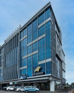 a large glass building with a bear on it at The Risman Hotel At Jakarta Airport CBC in Tangerang