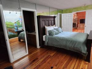 a bedroom with a bed and a large mirror at 8. Beautiful secluded creek front lodge in Guntersville
