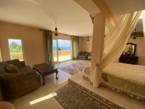 a bedroom with a canopy bed and a living room at Maroccana in Dobra Voda +77 photos