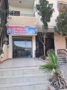 a building with a sign that reads guest home has interests at Sweet Home- No Egyptian in Hurghada