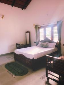 1 dormitorio con 1 cama grande y ventana en Taniva Dani by CoffeeBeanVilla en Sakleshpur