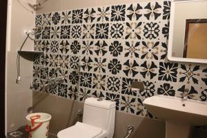 a bathroom with a toilet and a sink at Taniva Dani by CoffeeBeanVilla in Sakleshpur