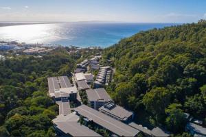 an aerial view of a building with trees and the ocean at 9408 Luxury Apartment Close to Hastings Street in Noosa Heads