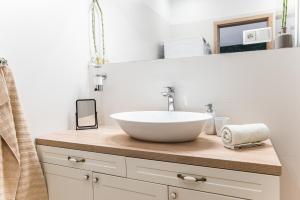 a bathroom with a bowl sink on a counter at New Spacious Apartment with City View in Košice +33 photos