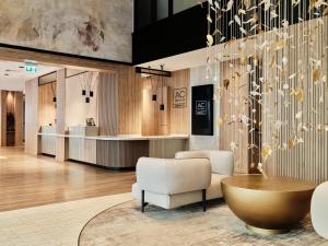 a lobby with chairs and a table and a counter at AC Hotel by Marriott Krakow in Krakow